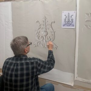 Piotr Wirkijowski works on a ceiling canvas in the Canning studio