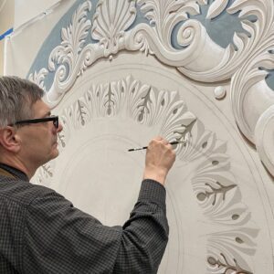Piotr Wirkijowski works on a ceiling canvas in the Canning studio