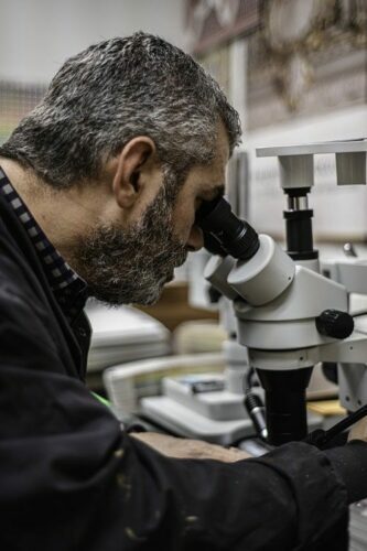 John Canning Co.'s David Riccio conducting a paint analysis through a microscope.